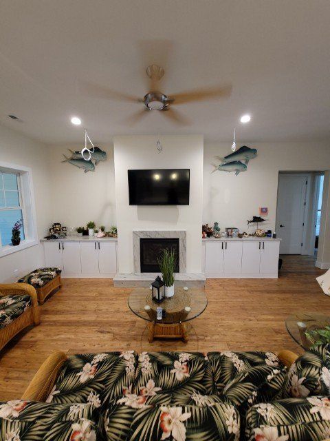 a living room with a fireplace , couch , coffee table and television .