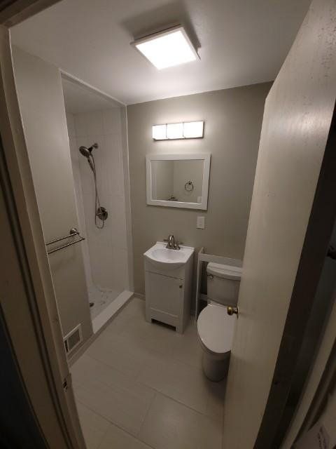 a bathroom with a sink , toilet , shower and mirror .