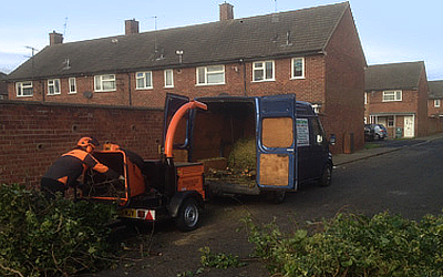 tree care machinery used in loading logs and branches in a van