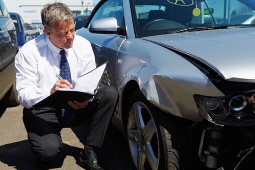 Loss adjuster inspecting wrecked car - Auto Insurance in Hemet, CA