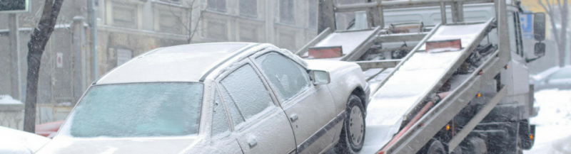 car being towed in snow