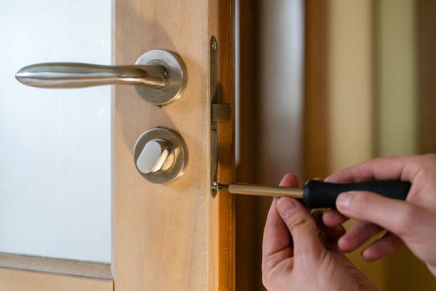 An image of a door handle and lock being replaced.