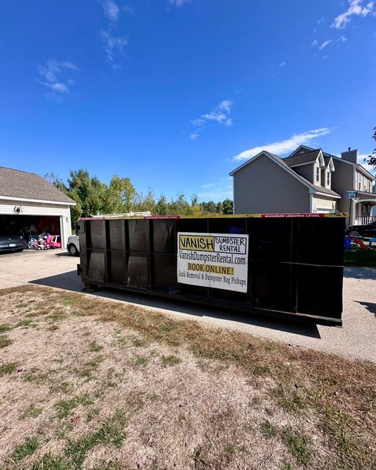 Vanish Dumpster Rental roll-off dumpster parked in a residential driveway