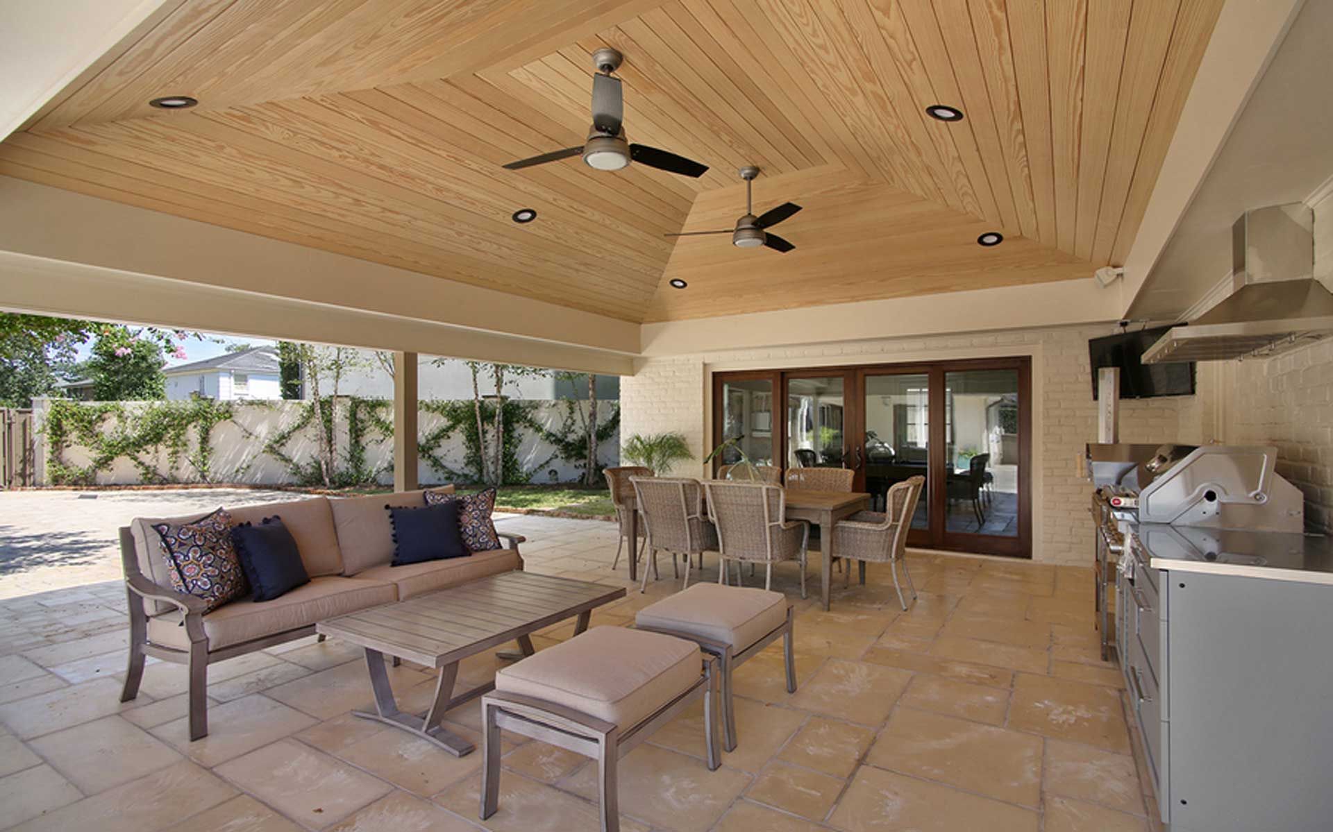 A patio with a ceiling fan and a table and chairs