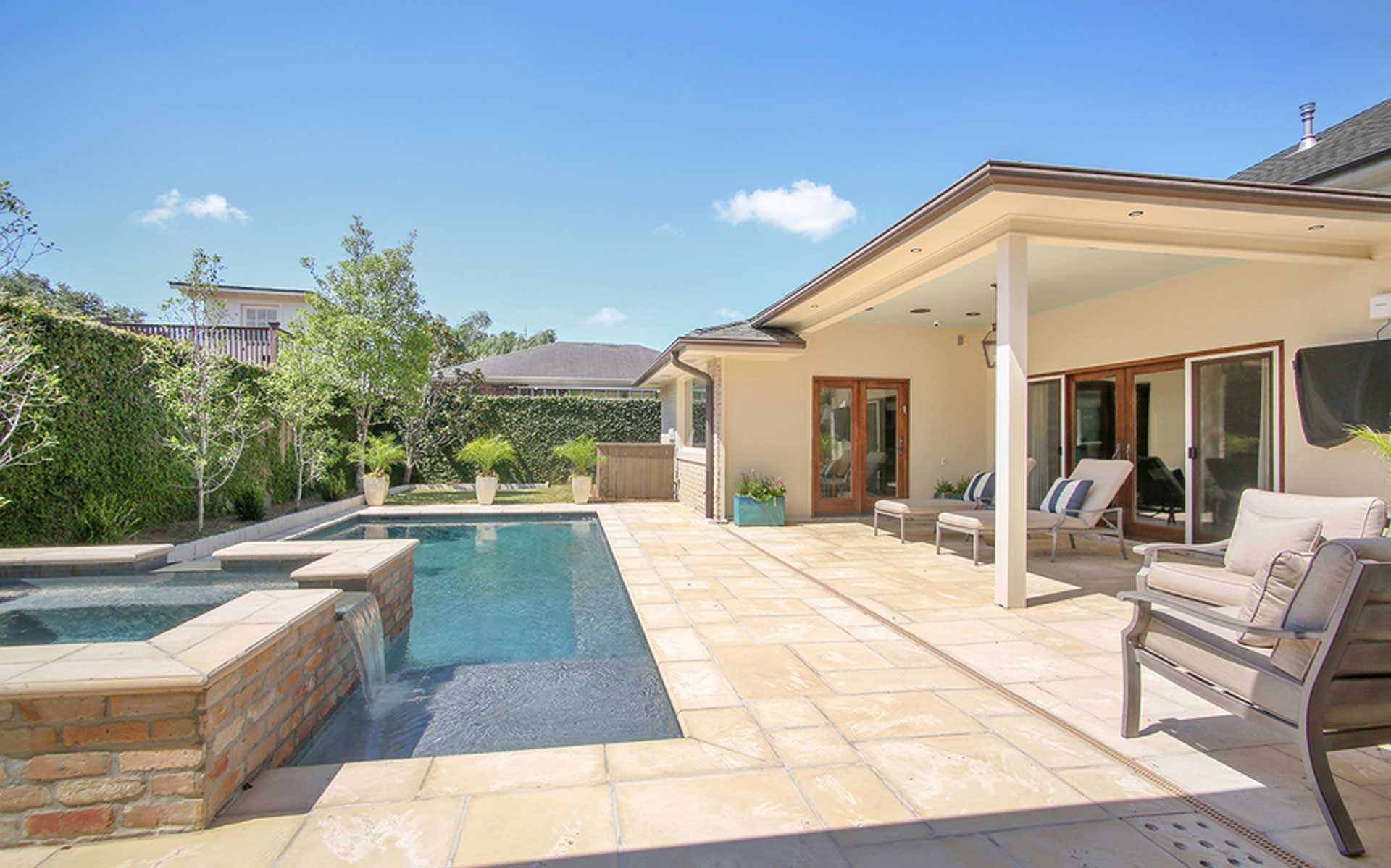 A house with a large swimming pool and patio area