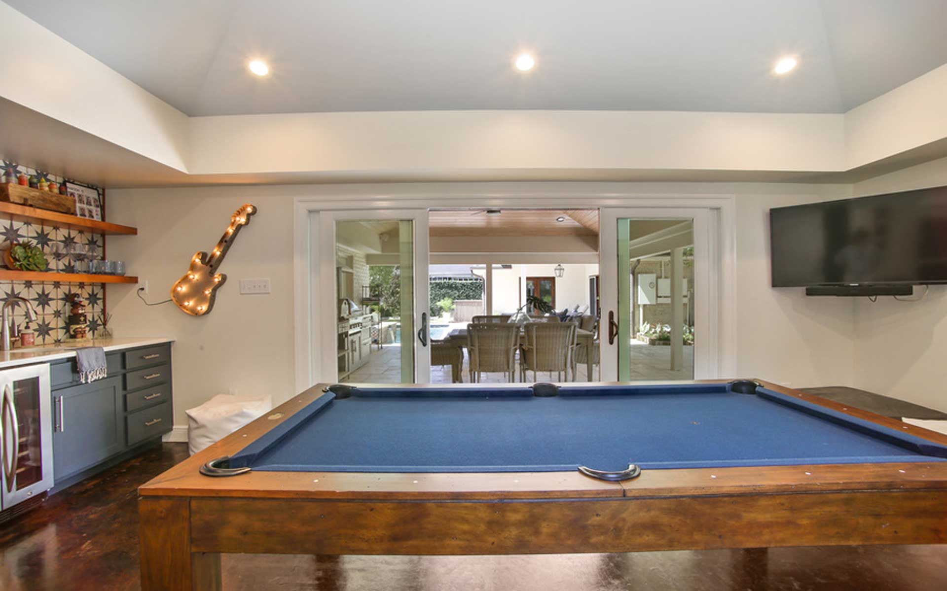 There is a pool table in the middle of the room.