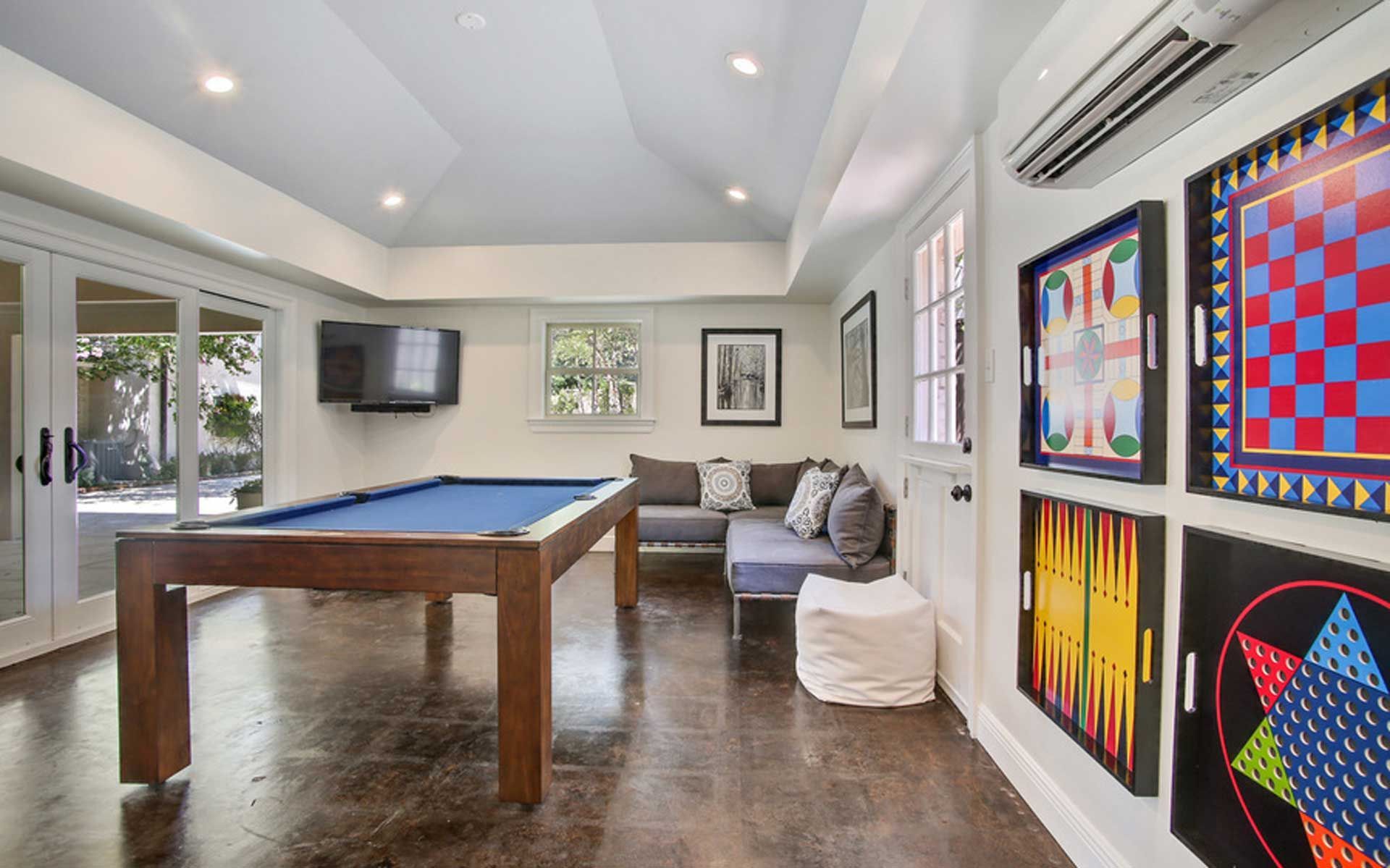 There is a pool table in the middle of the room.