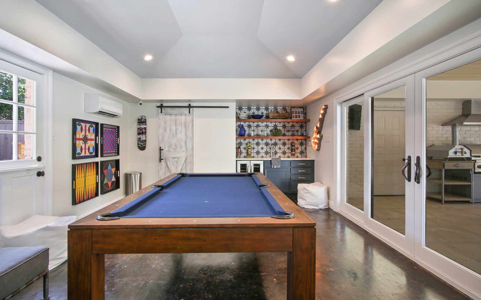 There is a pool table in the middle of the room.