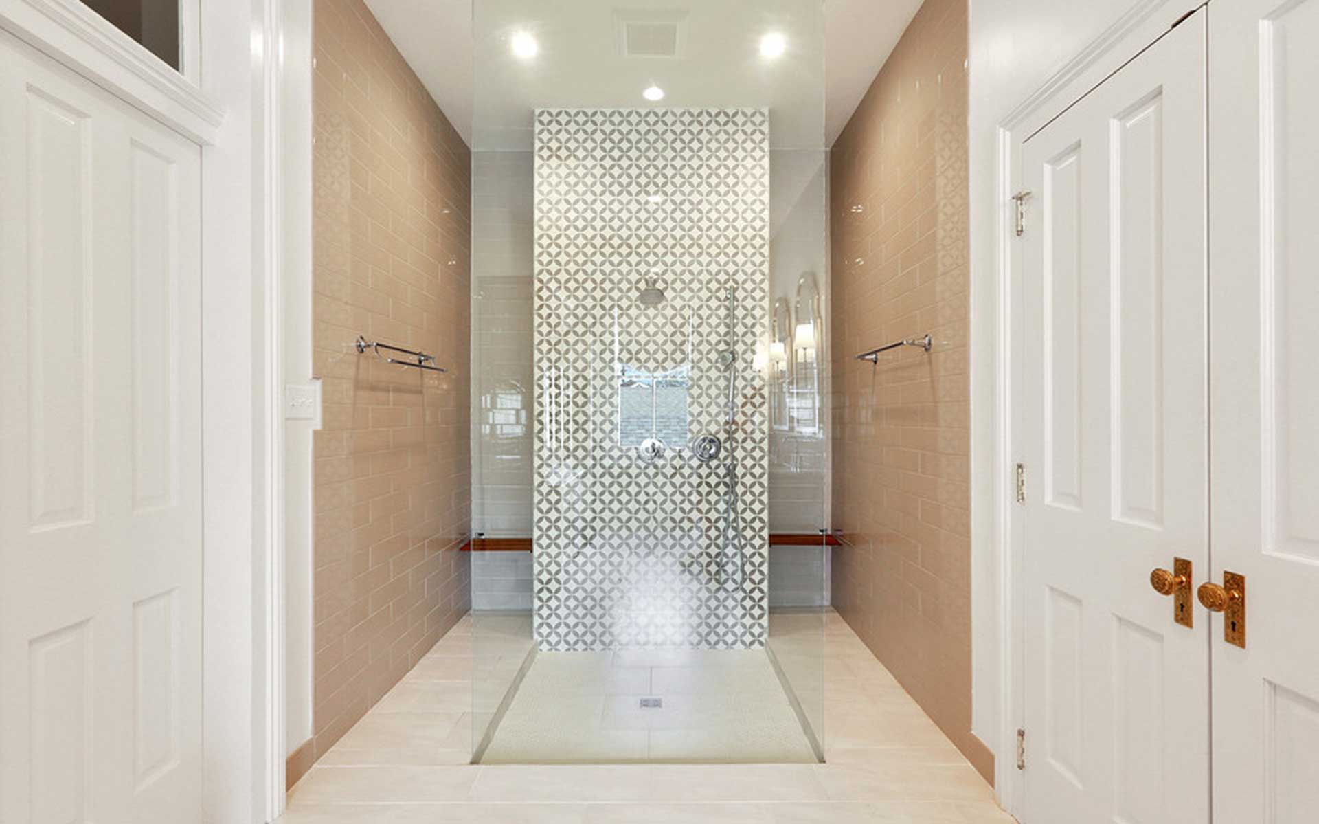A bathroom with a walk in shower and a tiled wall