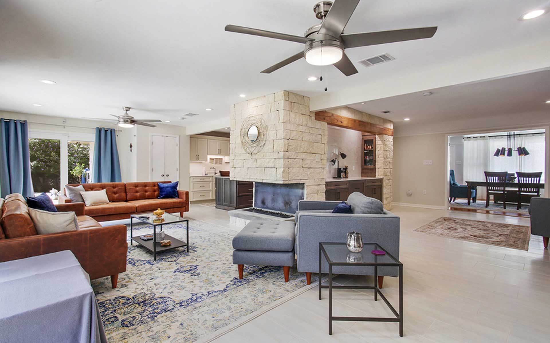 A living room filled with furniture and a ceiling fan.