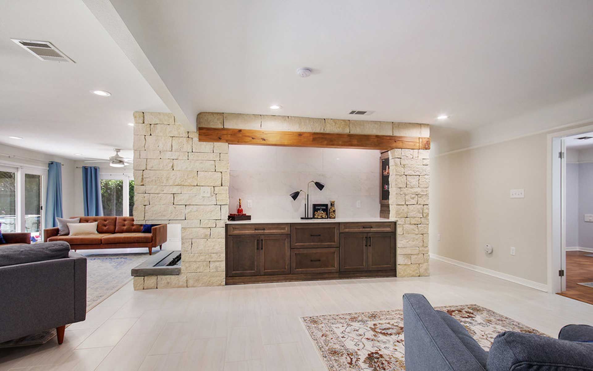 A living room with a couch , chairs , and a fireplace.