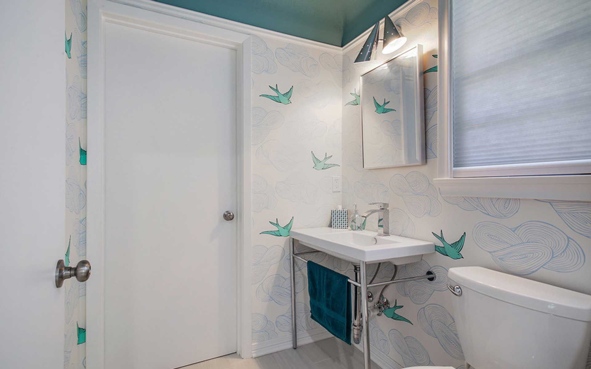 A bathroom with a sink , toilet and mirror.