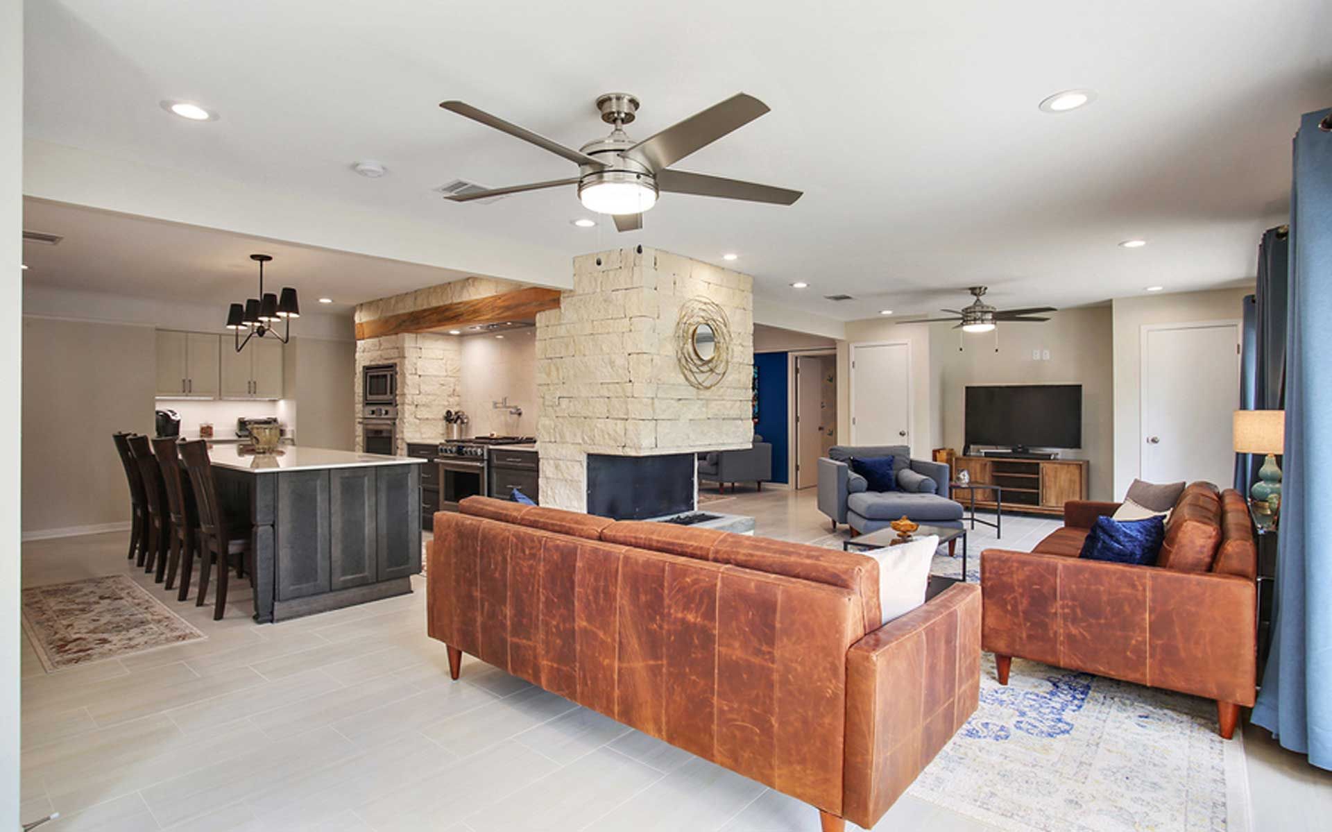 A living room filled with furniture and a ceiling fan.