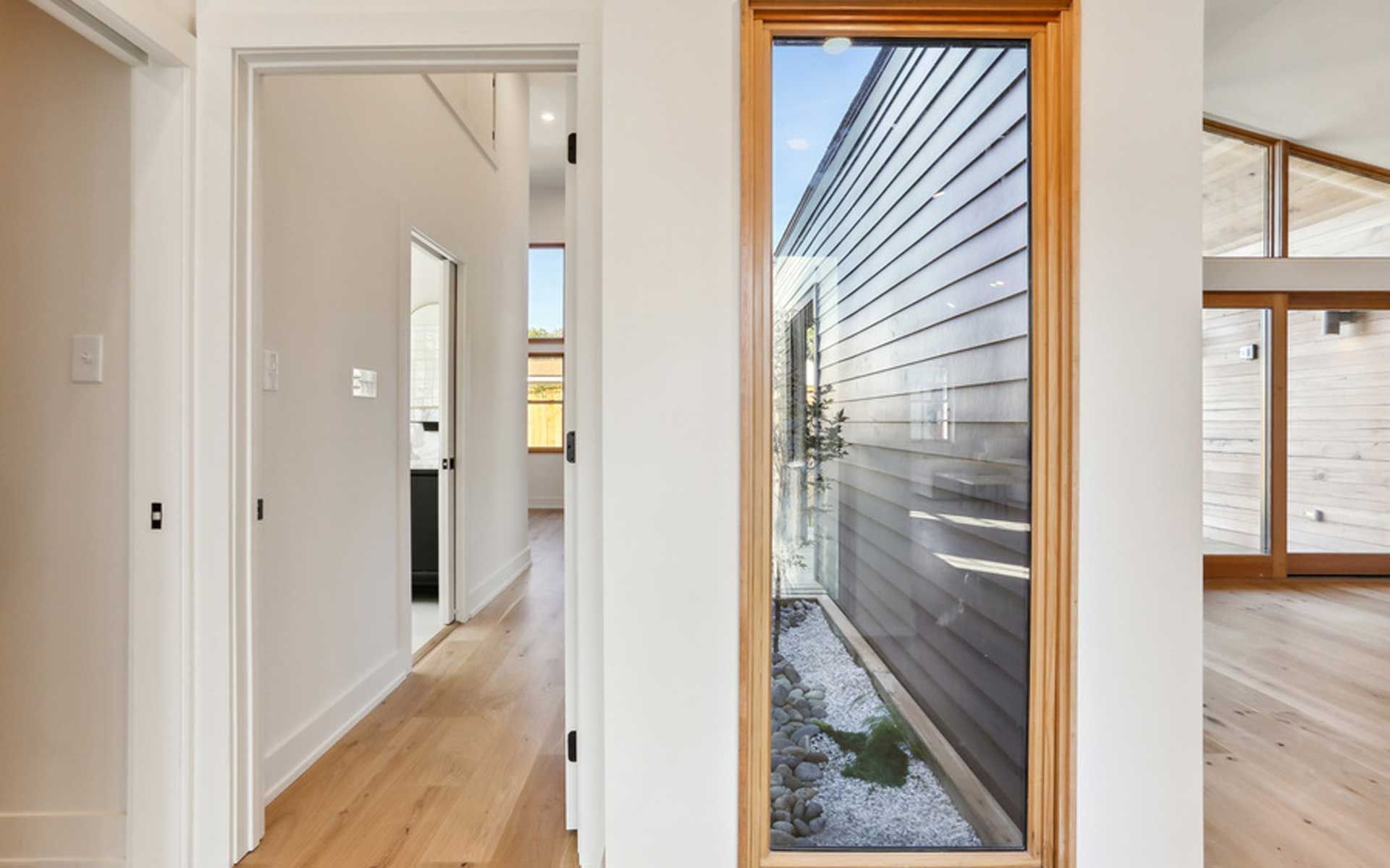 A hallway in a house with a large window