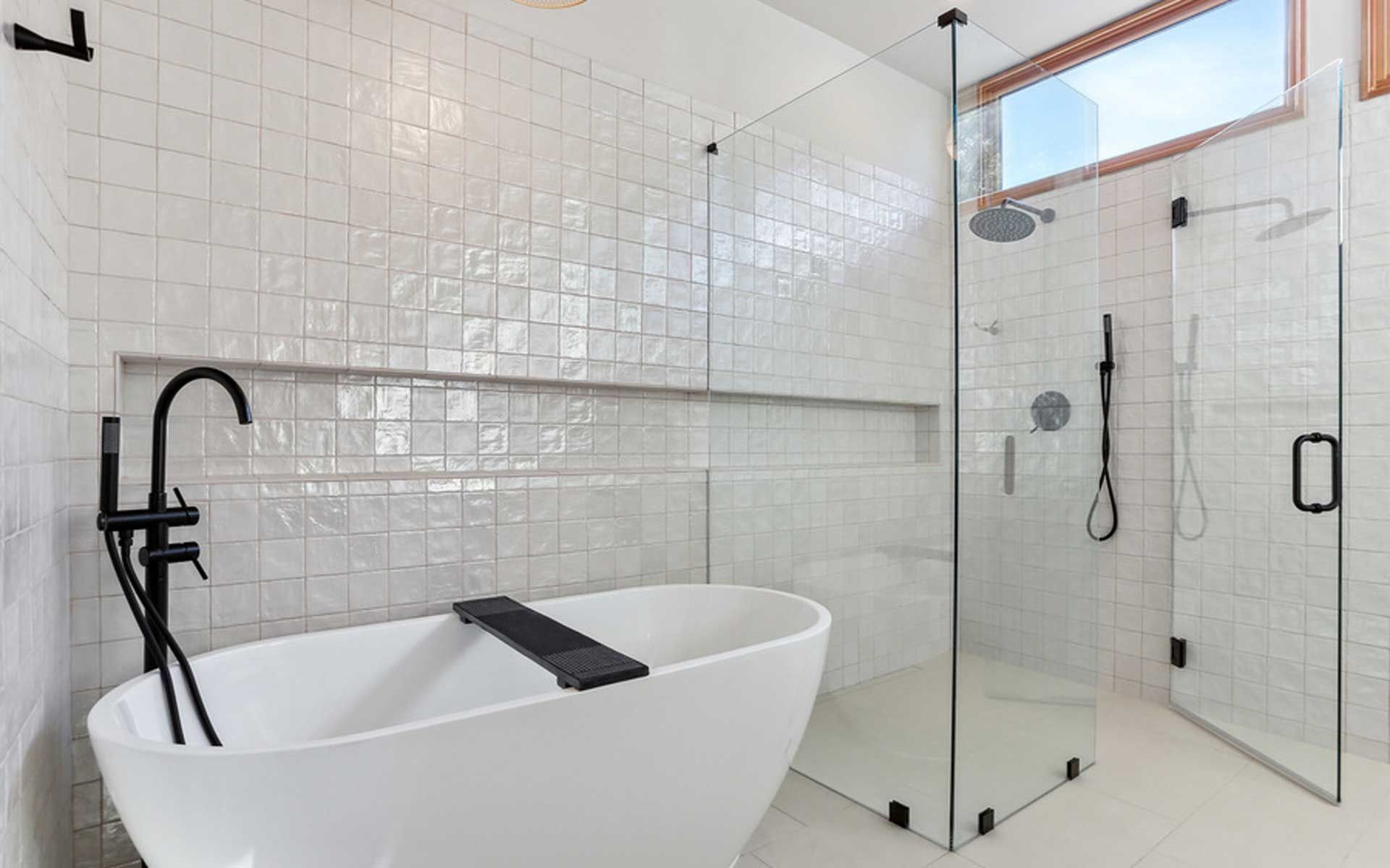 A bathroom with a bathtub and a walk in shower.