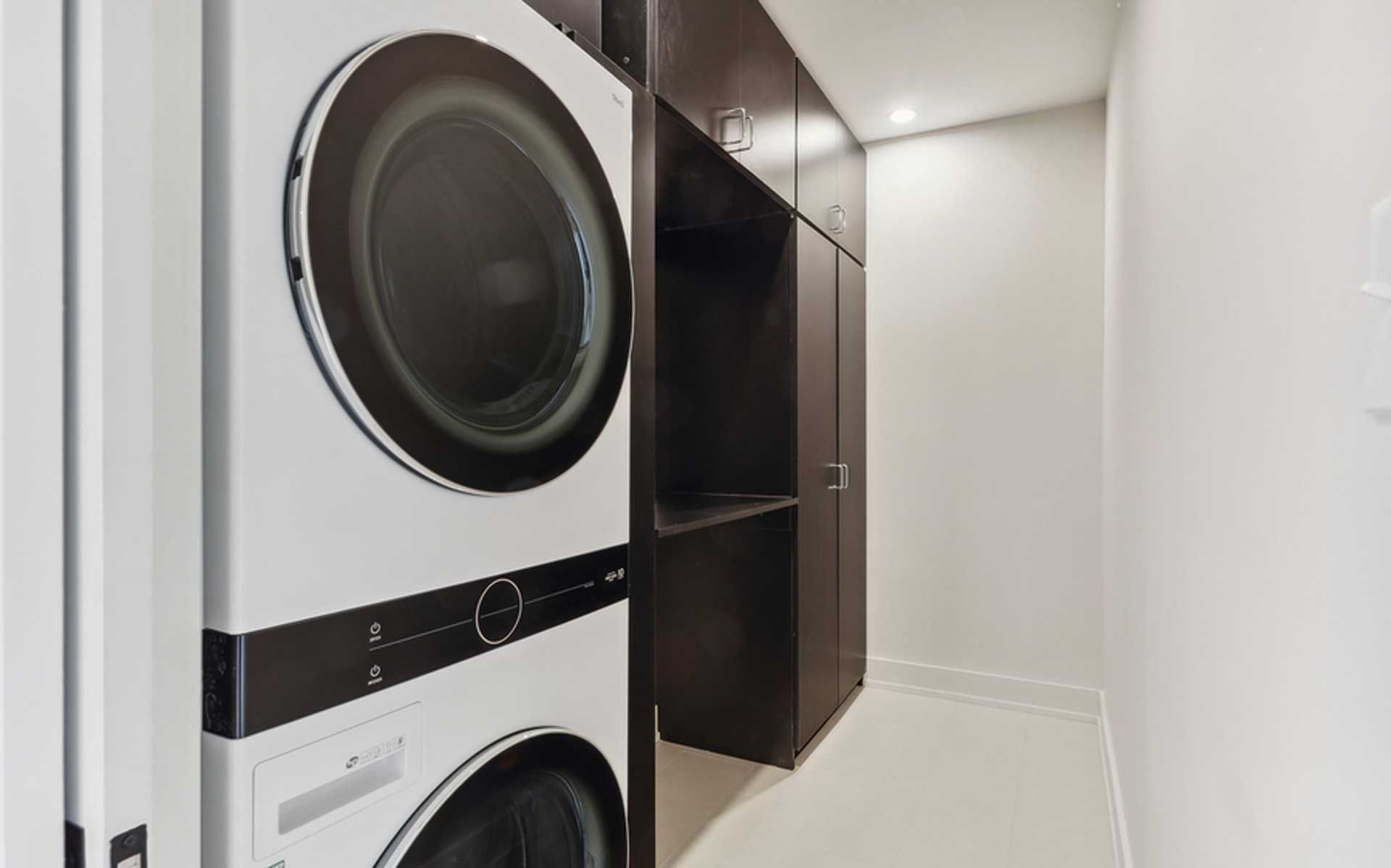 A washer and dryer are stacked on top of each other in a laundry room.