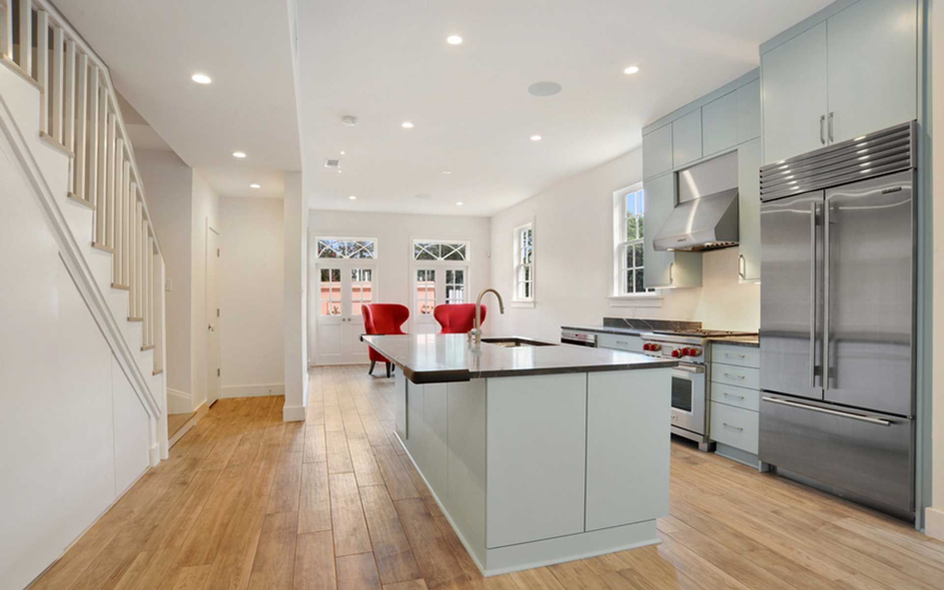 A kitchen with a large island and stainless steel appliances.
