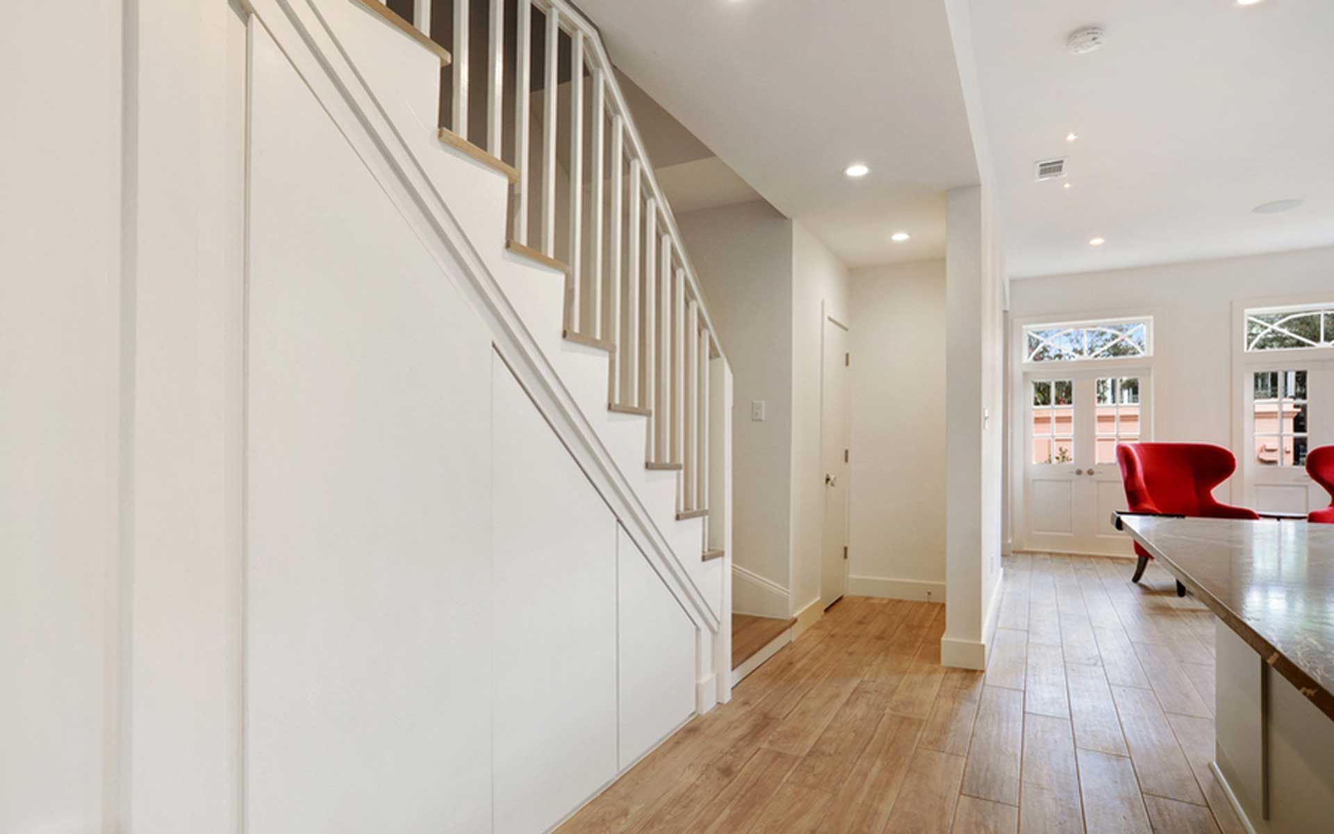 A hallway with stairs leading up to the second floor of a house.