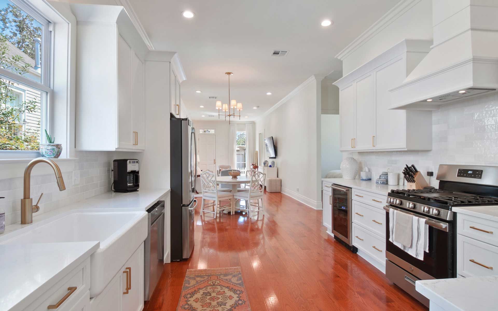 A kitchen with white cabinets and stainless steel appliances