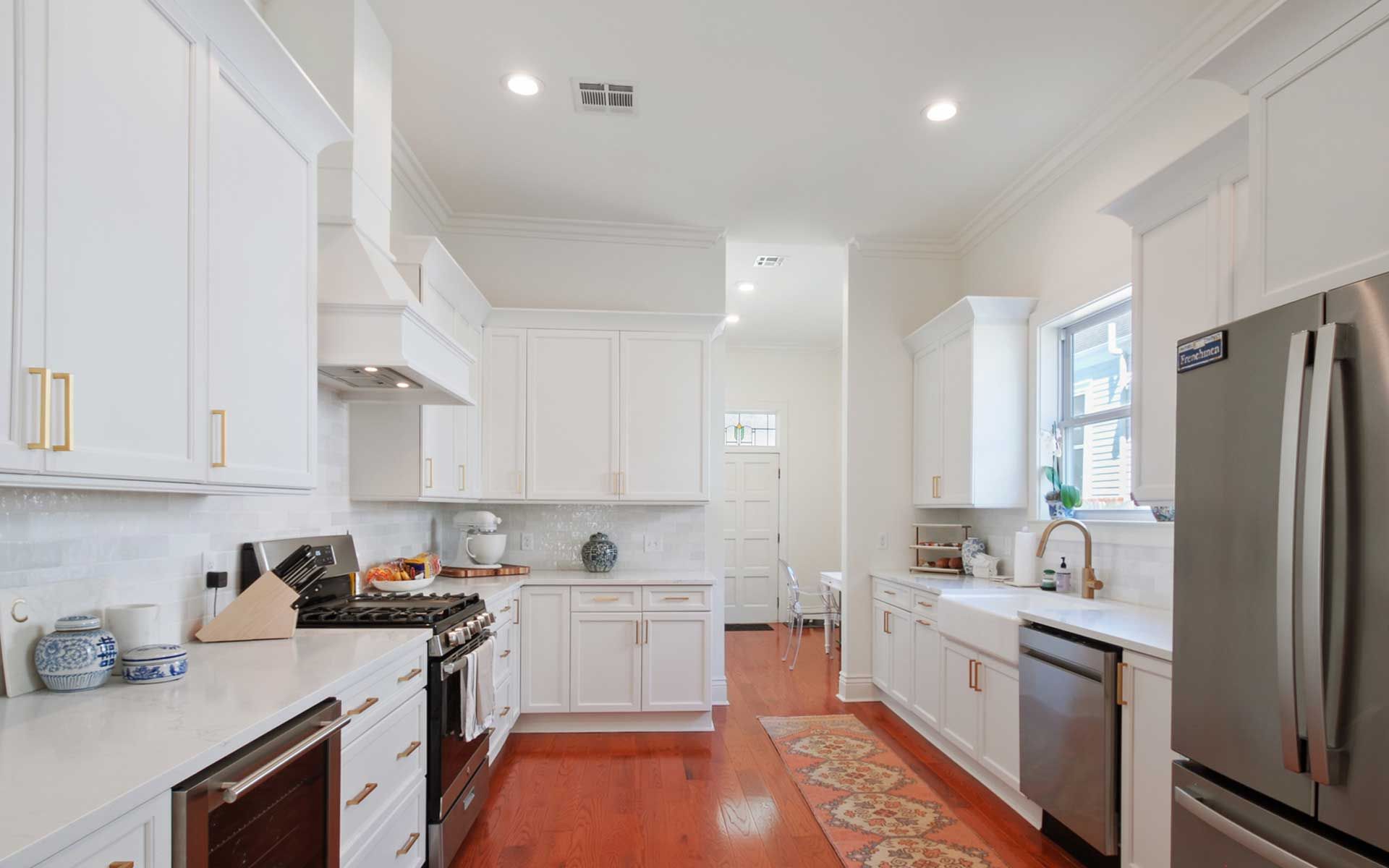 A kitchen with white cabinets and stainless steel appliances