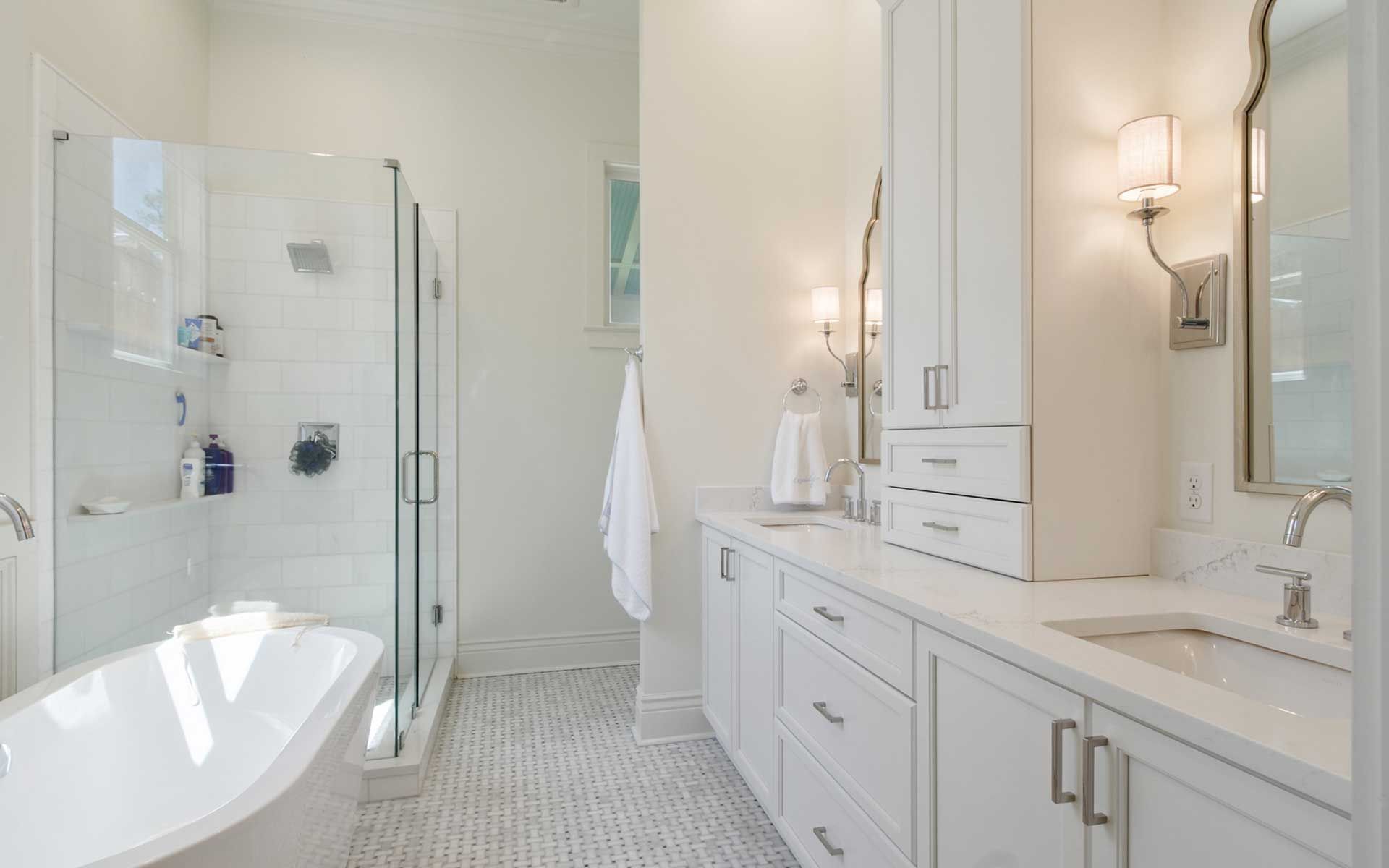 A bathroom with a tub , sink , and shower.