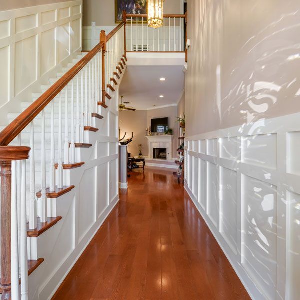 A hallway with stairs leading up to the second floor