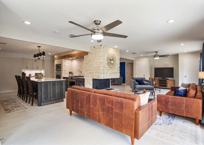 A living room filled with furniture and a ceiling fan.