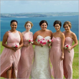 Emily and her bridesmaids in peach gowns