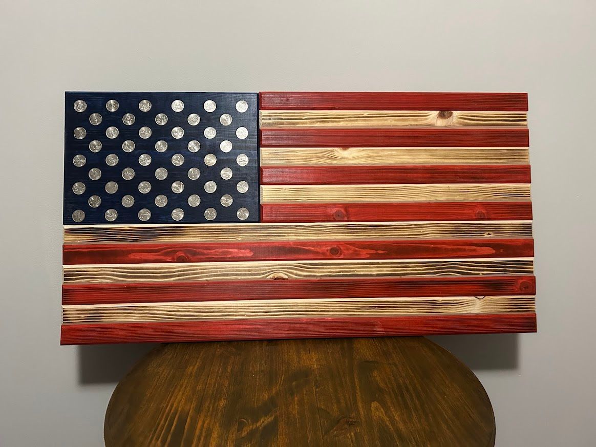 Wooden American flag with painted stripes, blue field with white dots.
