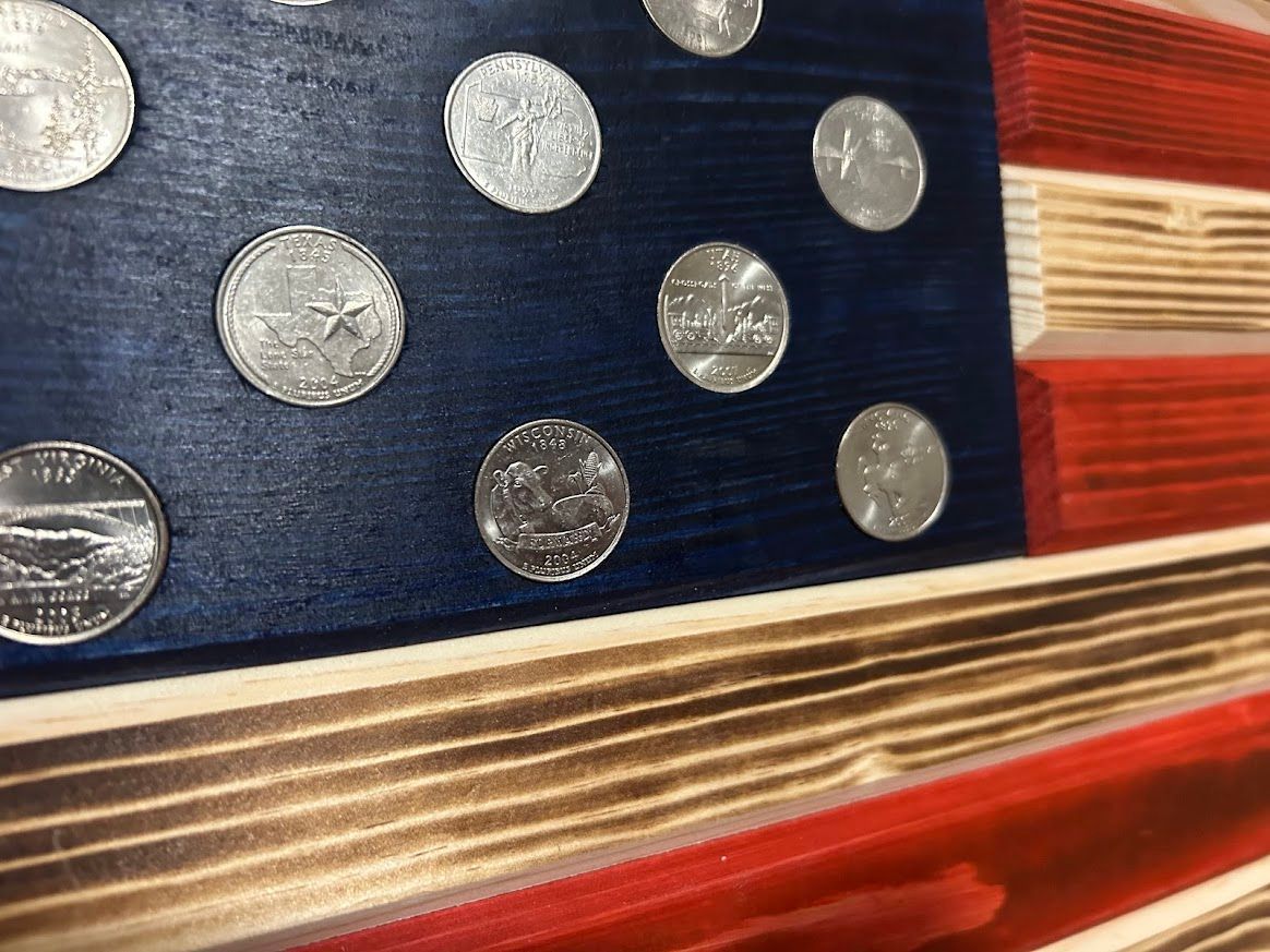 Wooden American flag with painted stripes, blue field with white dots.