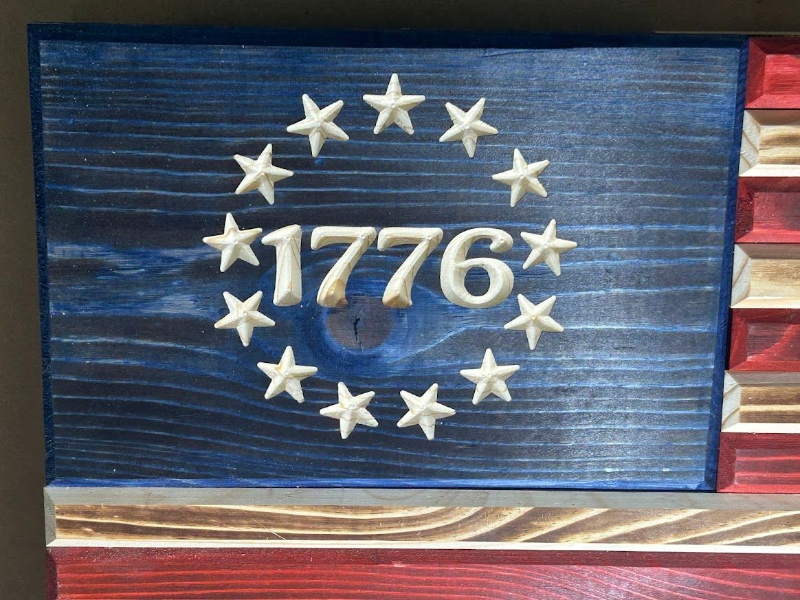 Wooden American flag with blue field featuring 1776 within a circle of stars.
