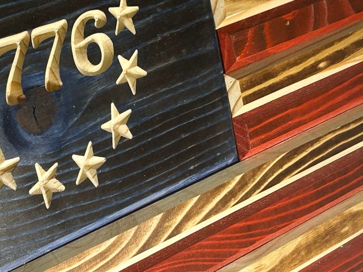 Wooden American flag with stars, 1776, and red/blue/white stripes.