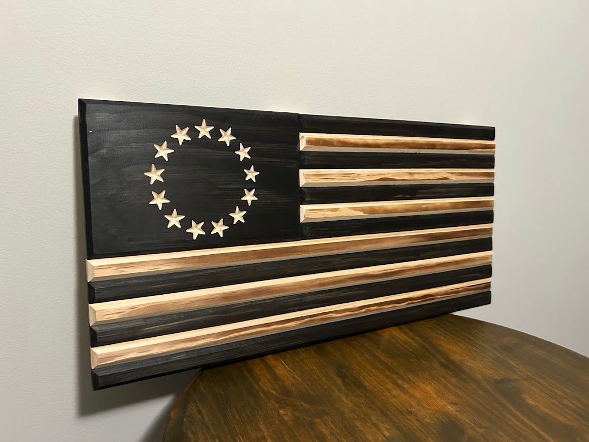 Wooden Betsy Ross flag, black and natural wood, 13 stars in a circle.