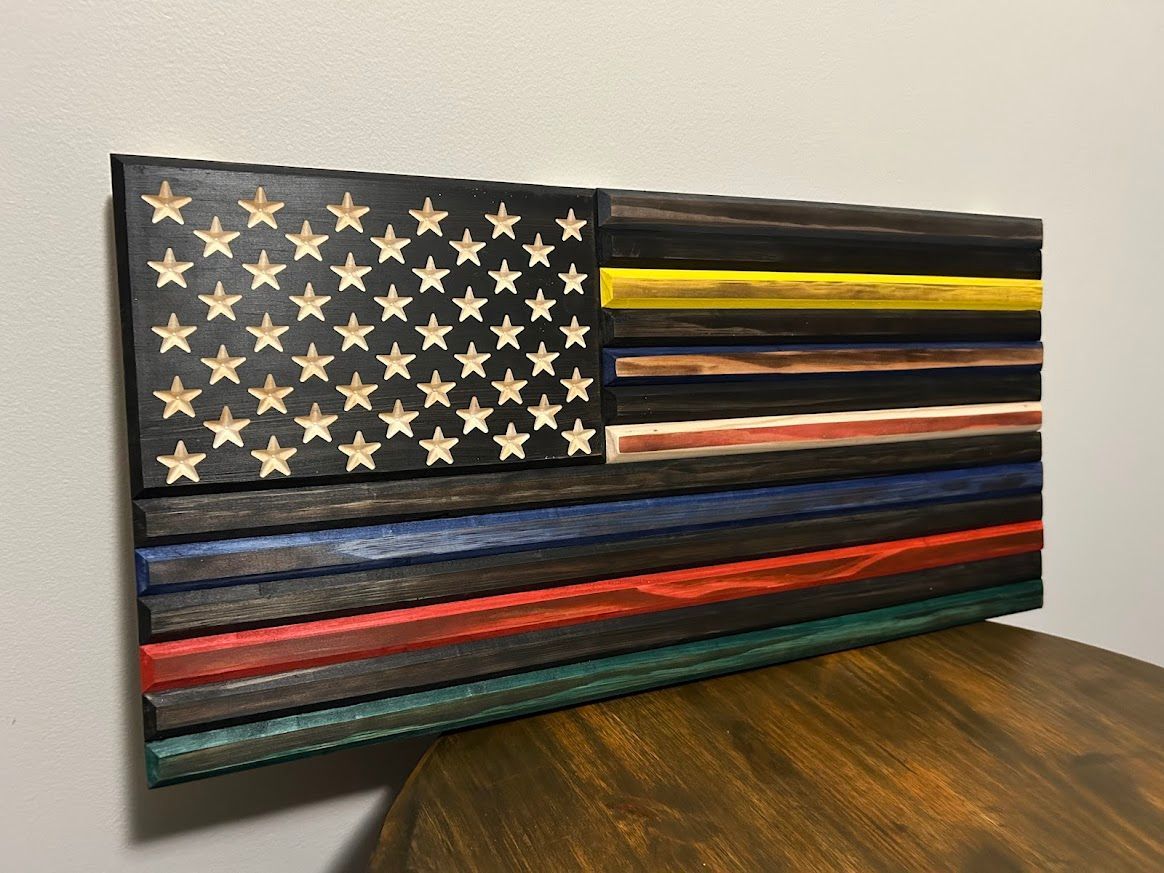Wooden flag art with the American flag design, including blue, red, yellow and green stripes.