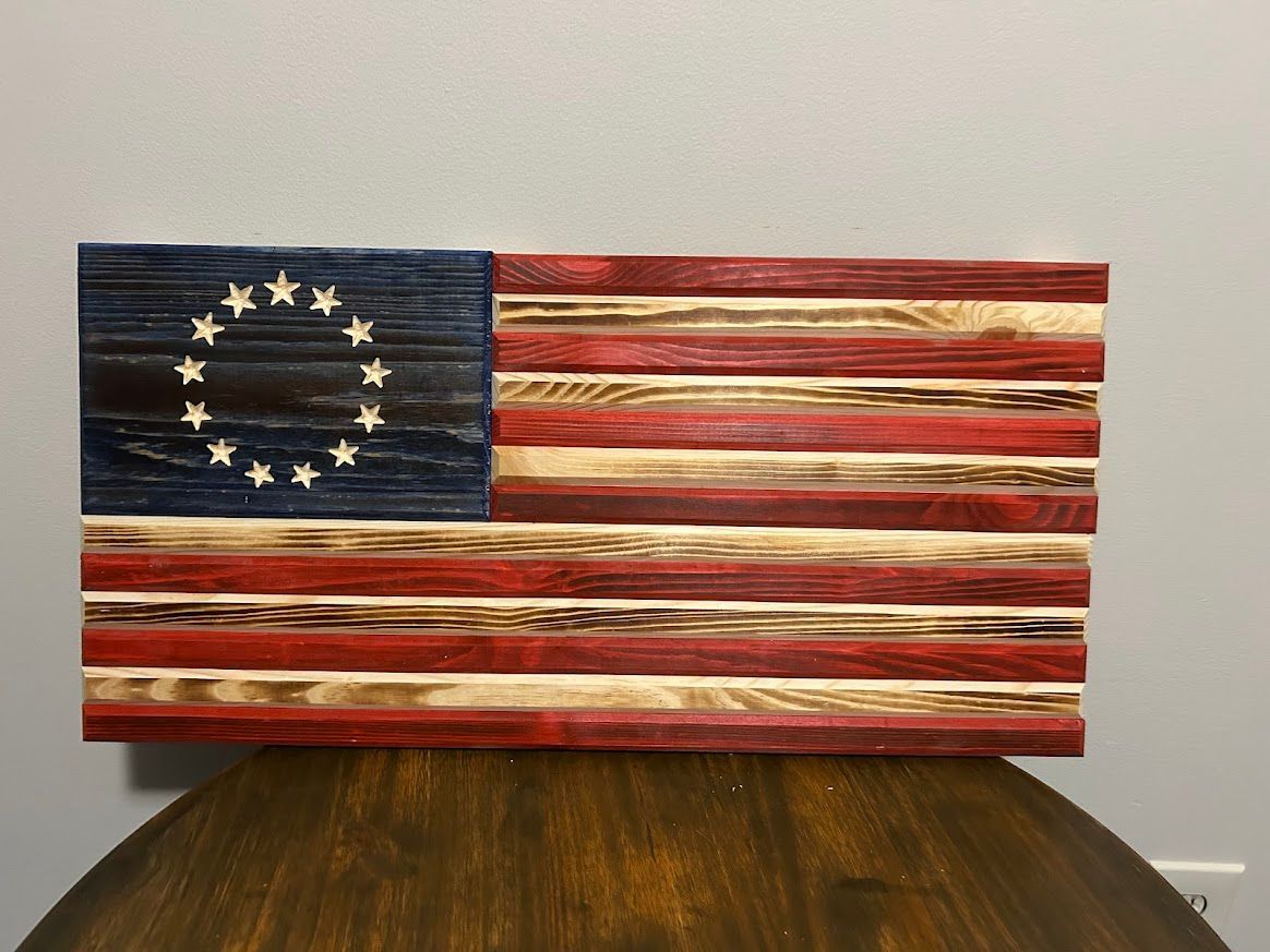 Wooden Betsy Ross flag, red and white stripes, blue star field.