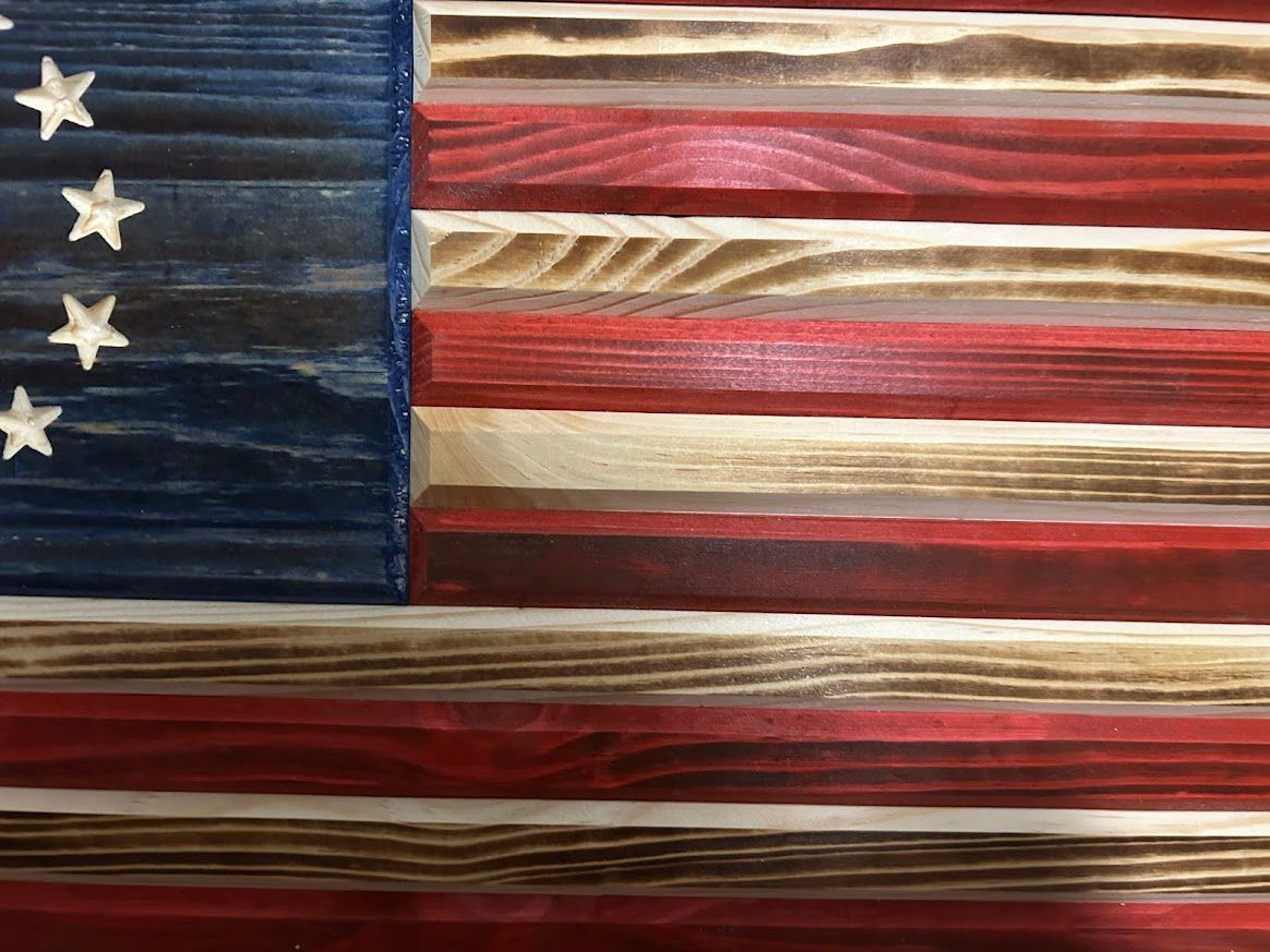 Wooden Betsy Ross flag, red and white stripes, blue star field.