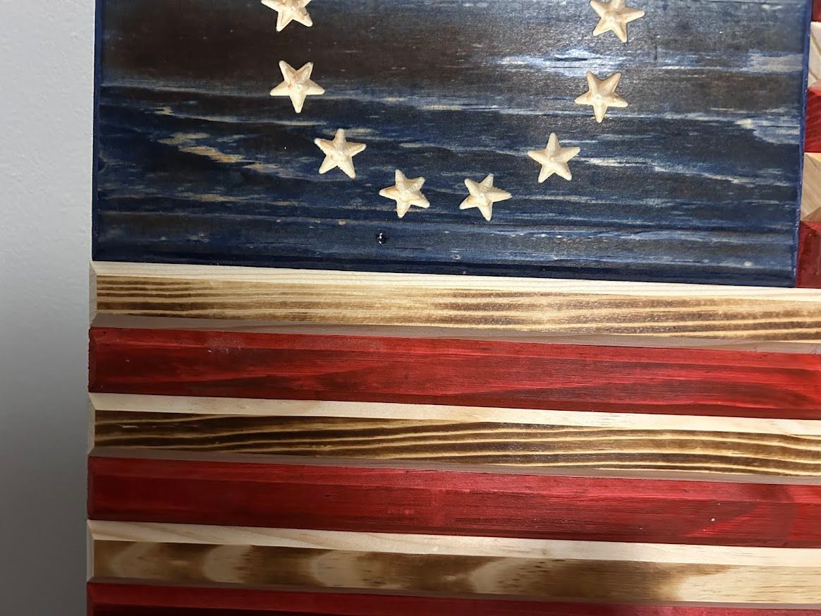 Wooden American flag with stars and stripes, stained blue, red, and natural wood.