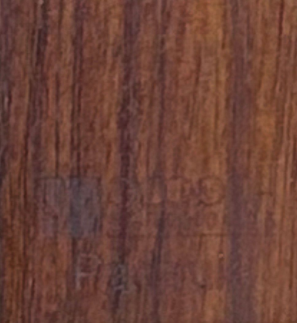 Wooden cabinet displaying wood samples on a workbench in a workshop.