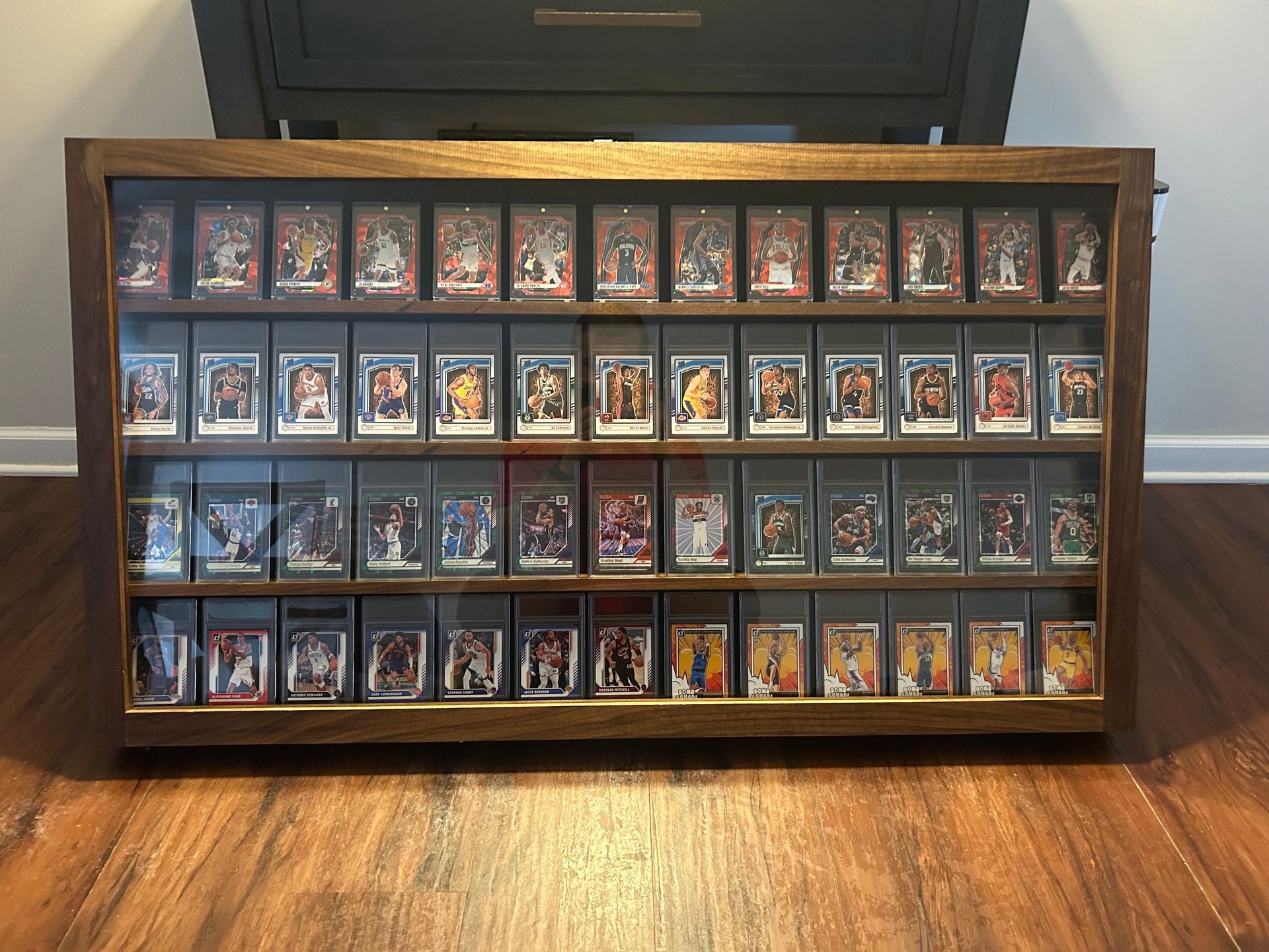 Wooden display case holding various wood samples on a workbench.