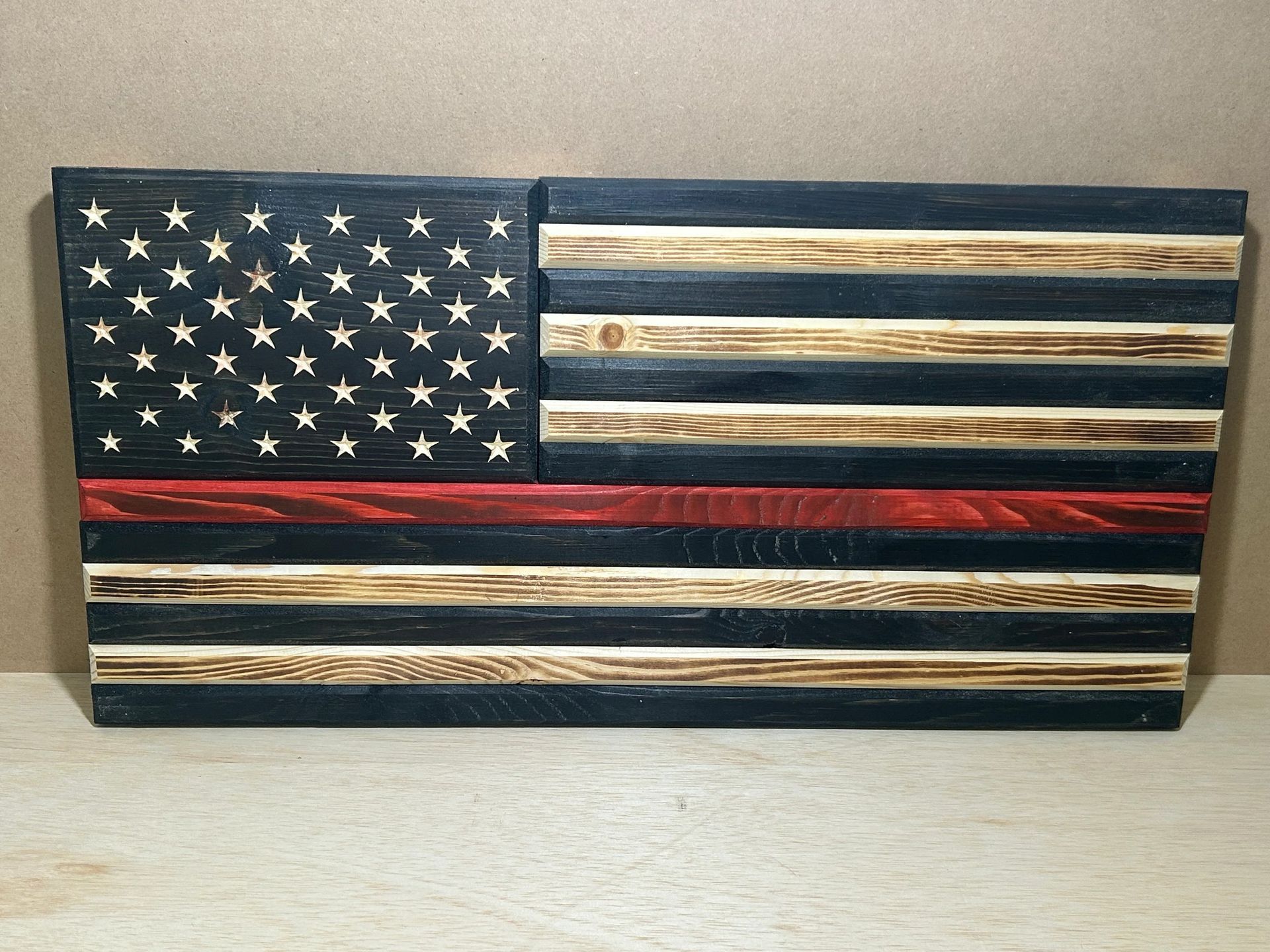 Wooden American flag with a red stripe, the “Thin Red Line” for firefighters.
