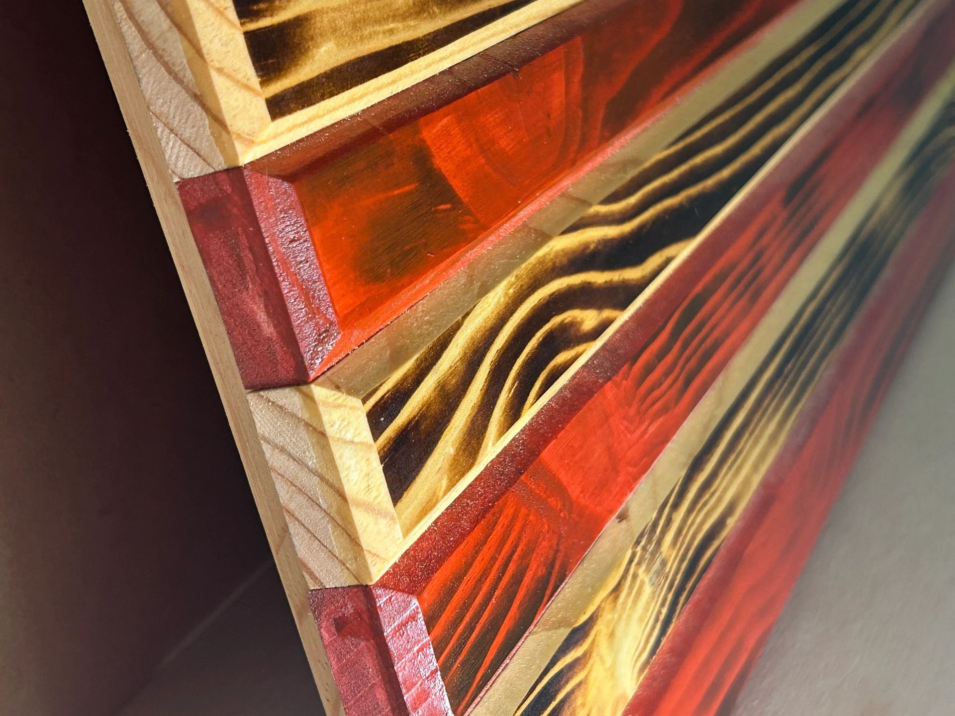 Wooden American flag, stars on blue field, red and natural wood stripes.