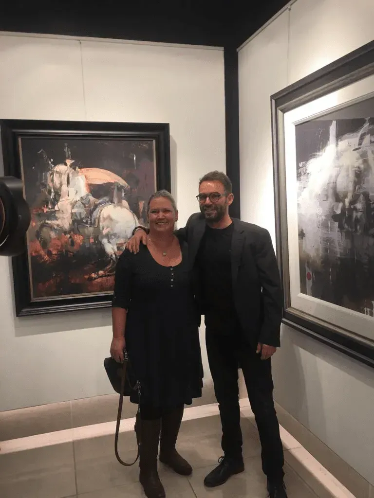 Debbie Nuttall Artist | a man and a woman pose in front of a painting