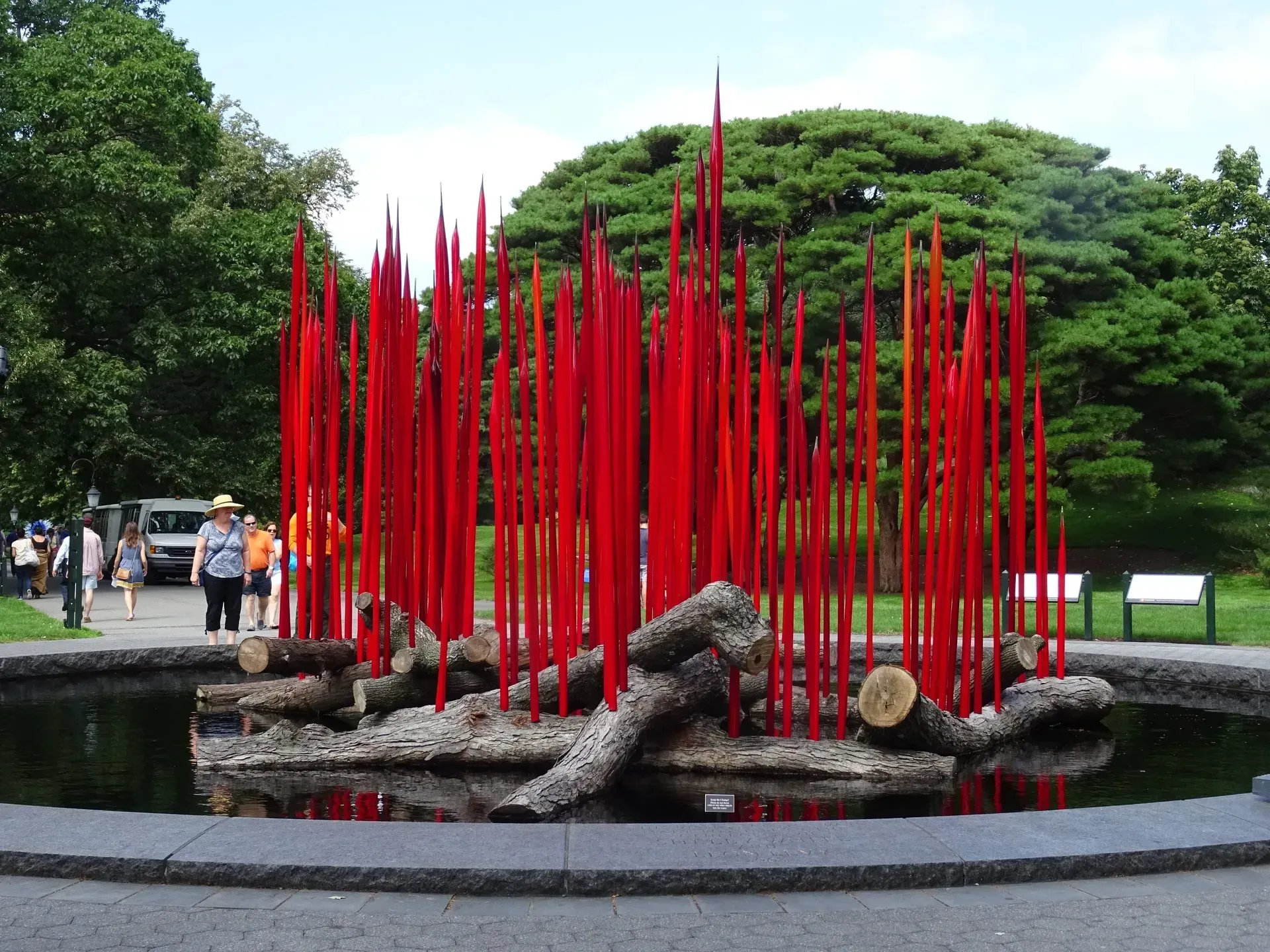 Debbie Nuttall Artist | a fountain with red sticks and logs in it