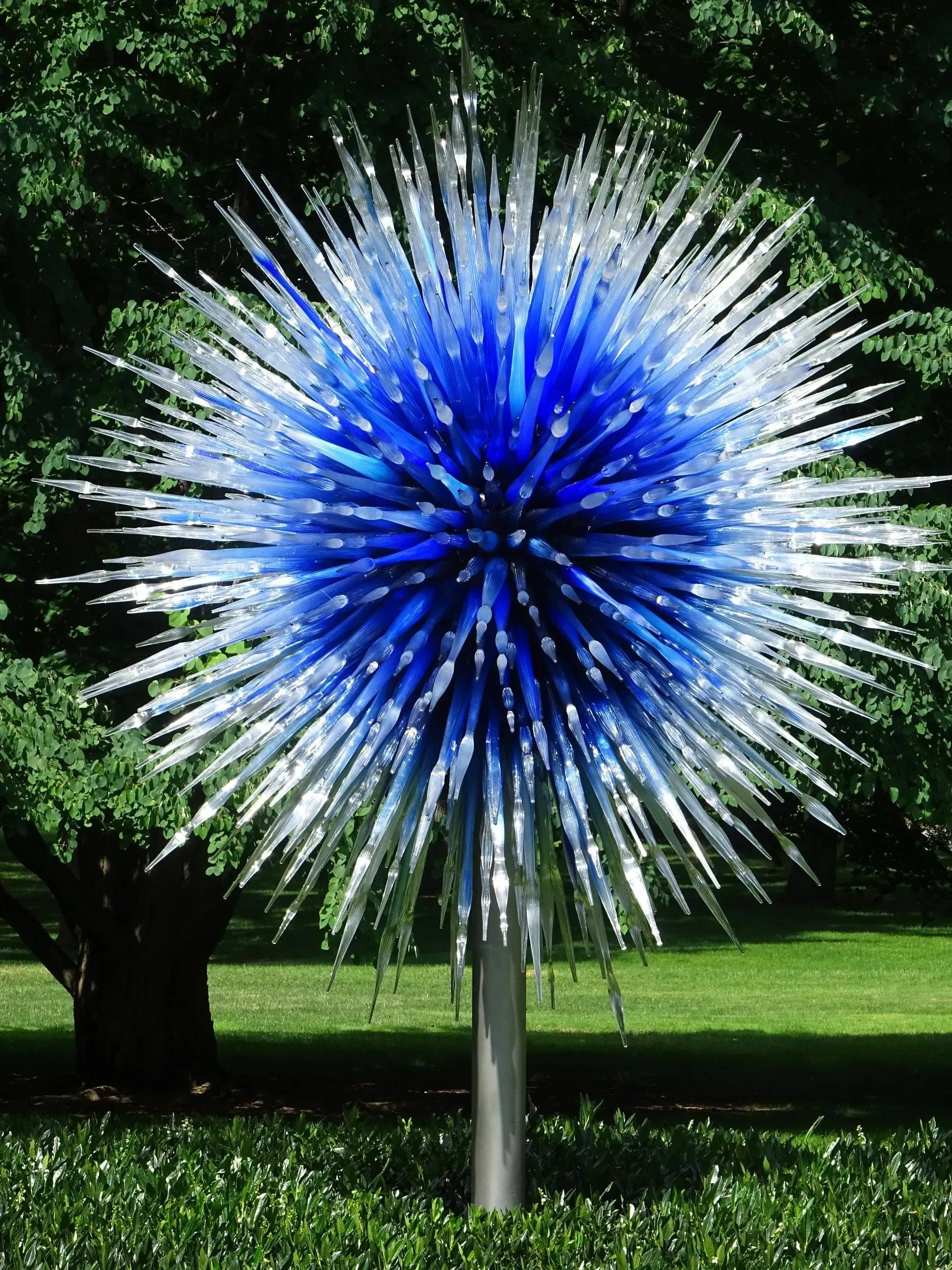 Debbie Nuttall Artist | a blue and white sculpture in a park with trees in the background