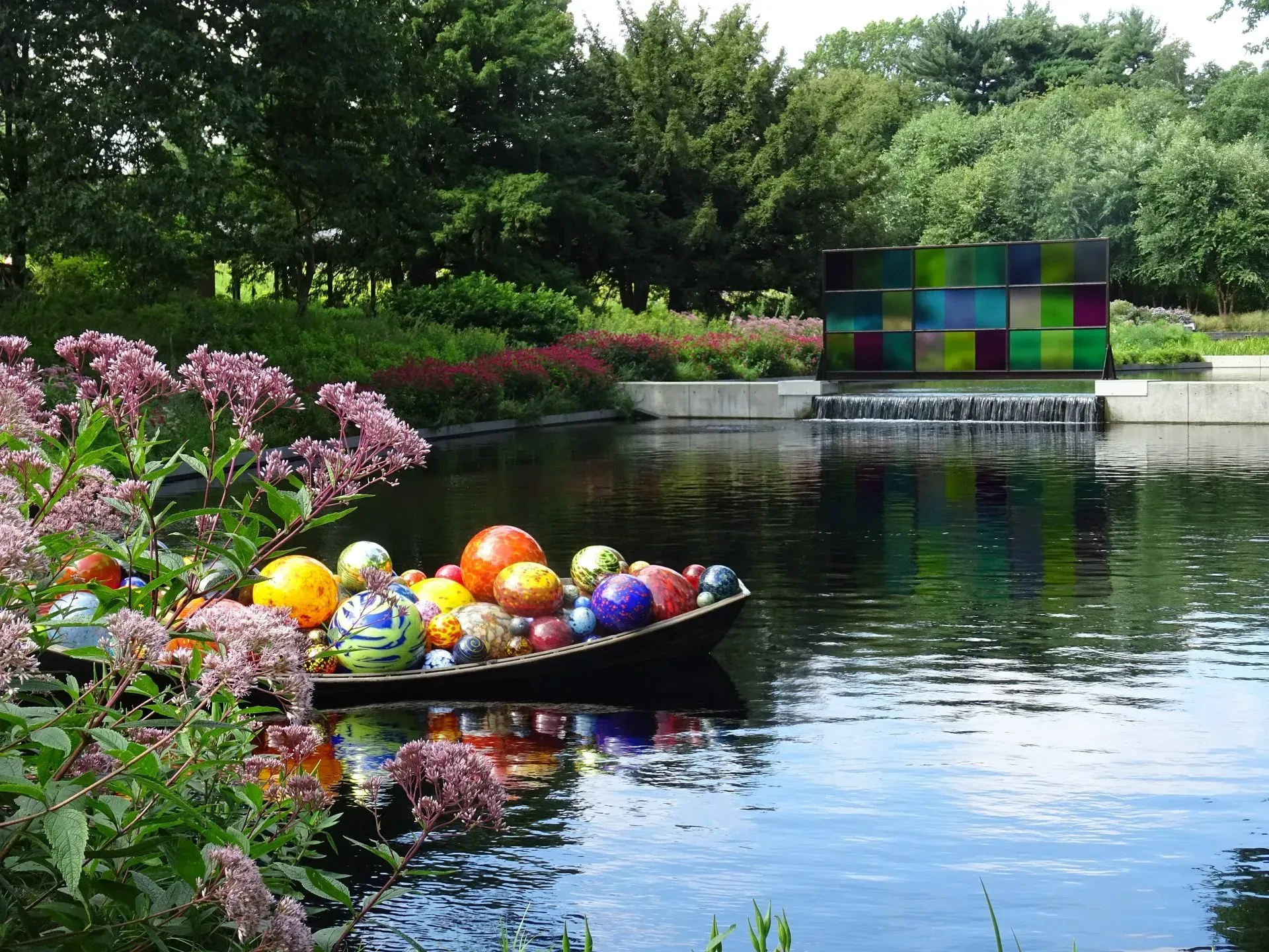 Debbie Nuttall Artist | a boat filled with colorful glass balls is in the water