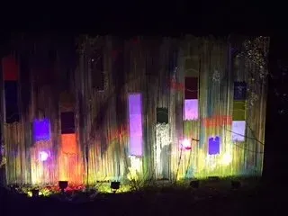 Debbie Nuttall Artist | a building with a lot of windows is lit up at night .