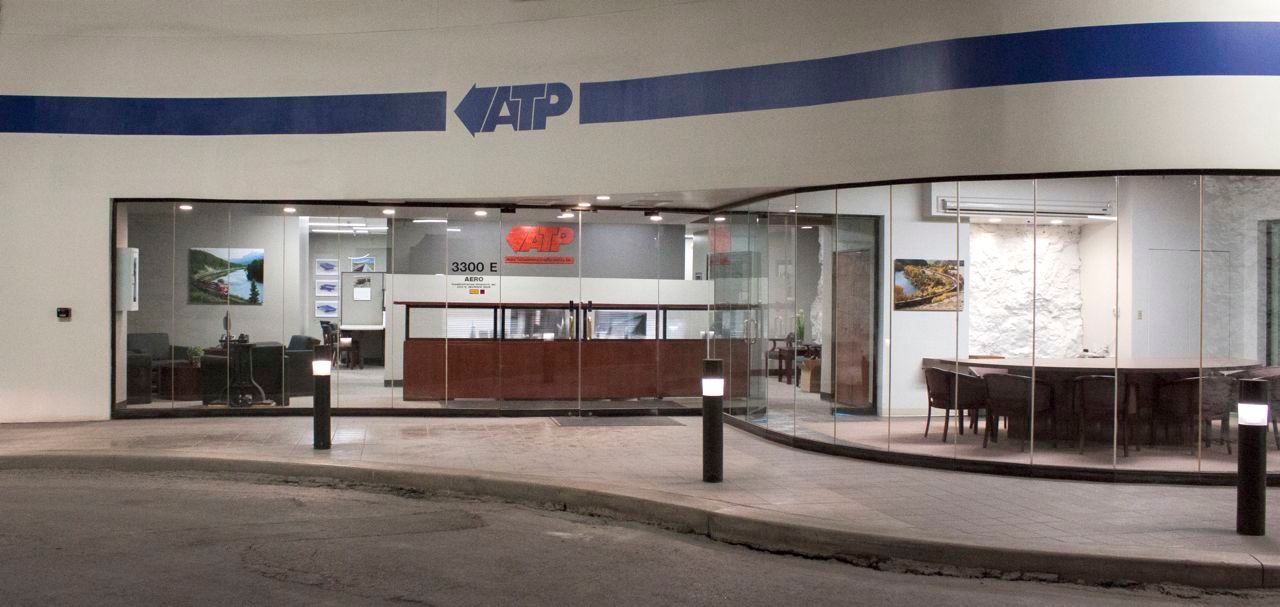 A white building with a blue stripe on the side of it