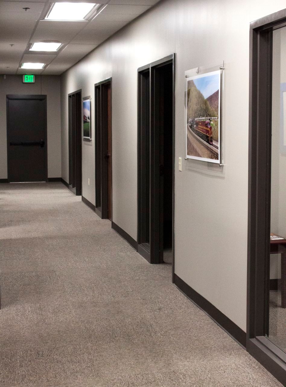 A long hallway with a picture of a train on the wall