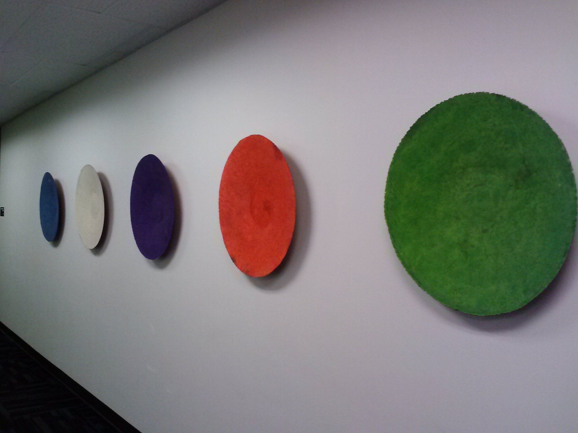 A row of colorful circles on a white wall