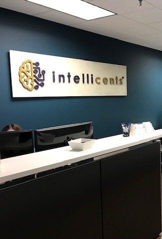 A reception desk with a sign above it that says `` intelligents ''.